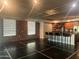 Spacious living area with dark floors, brick accent wall, open kitchen, and modern lighting at 6803 E Main St # 4415, Scottsdale, AZ 85251