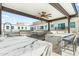 Modern outdoor kitchen with marble counters, stainless steel grill, sink, and covered dining area at 6803 E Main St # 4415, Scottsdale, AZ 85251