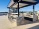 Stunning outdoor kitchen with modern appliances and marble countertop bar area with seating and mountain views at 6803 E Main St # 4415, Scottsdale, AZ 85251