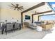 Rooftop terrace boasting multiple seating areas, ceiling fans, and an outdoor television for relaxing at 6803 E Main St # 4415, Scottsdale, AZ 85251