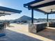 Outdoor rooftop area with a full kitchen, lounge seating, dining table, and mountain views at 6803 E Main St # 4415, Scottsdale, AZ 85251