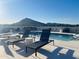 Beautiful rooftop pool with lounge chairs and stunning mountain views, providing a luxurious outdoor experience at 6803 E Main St # 4415, Scottsdale, AZ 85251