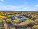 An aerial view of a desert home with a pool, a lush lawn, an outdoor bar, and mature desert landscaping at 7130 E Navarro Way, Scottsdale, AZ 85266