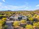 Aerial view of a desert home showcases mature landscaping, mountain views, and ample privacy at 7130 E Navarro Way, Scottsdale, AZ 85266