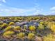 Aerial view captures the desert home surrounded by flowering trees, providing a vibrant setting at 7130 E Navarro Way, Scottsdale, AZ 85266