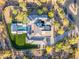 Overhead view of a sprawling estate with a large home, pool area, putting green, and landscaped desert grounds at 7130 E Navarro Way, Scottsdale, AZ 85266