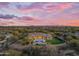 Expansive desert home featuring a private pool, outdoor seating, artificial turf, and desert views at 7130 E Navarro Way, Scottsdale, AZ 85266