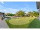 Lush backyard featuring a putting green, outdoor kitchen, and mature trees, ideal for recreational activities at 7130 E Navarro Way, Scottsdale, AZ 85266