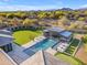 Backyard featuring a pool with cabana, putting green, manicured lawn, and desert landscape, perfect for outdoor living at 7130 E Navarro Way, Scottsdale, AZ 85266