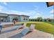 Inviting backyard with lounge chairs on a paved patio, overlooking the lawn and elegant home at 7130 E Navarro Way, Scottsdale, AZ 85266
