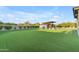 Expansive backyard with lush artificial turf and a modern outdoor pavilion with views at 7130 E Navarro Way, Scottsdale, AZ 85266