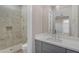Bathroom with white quartz countertop, gray vanity and tiled shower at 7130 E Navarro Way, Scottsdale, AZ 85266
