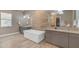 Luxurious bathroom featuring a soaking tub, dual vanities, designer lighting, and modern fixtures at 7130 E Navarro Way, Scottsdale, AZ 85266