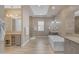 Bright bathroom featuring a soaking tub, tiled floors, and dual vanities for a spa-like experience at 7130 E Navarro Way, Scottsdale, AZ 85266
