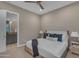Comfortable bedroom with ceiling fan showing an ensuite bathroom with modern features and elegant fixtures at 7130 E Navarro Way, Scottsdale, AZ 85266