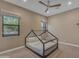 Neutral bedroom features unique bed frame, fan, and large window at 7130 E Navarro Way, Scottsdale, AZ 85266