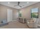 Bedroom features a ceiling fan, two windows, and neutral tones at 7130 E Navarro Way, Scottsdale, AZ 85266