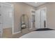 Cozy bedroom showcasing a full-length mirror, multiple doorways, and glimpses of a connected living space at 7130 E Navarro Way, Scottsdale, AZ 85266