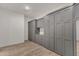 Large custom closet with built-in gray storage cabinets, drawers, and shelves maximizing space and organization at 7130 E Navarro Way, Scottsdale, AZ 85266