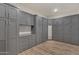 A custom closet with gray cabinets, drawers, and a mirror, providing ample storage and organization space at 7130 E Navarro Way, Scottsdale, AZ 85266