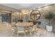 Bright dining room with a round table, stone accent wall, and wine cellar views at 7130 E Navarro Way, Scottsdale, AZ 85266