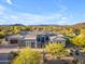 Exterior of a modern home with desert landscaping, a multi-car garage, and views of mountains in the background at 7130 E Navarro Way, Scottsdale, AZ 85266