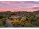 Desert home featuring a multi-car garage, decorative landscaping, and mountain views in the background at 7130 E Navarro Way, Scottsdale, AZ 85266