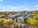 Beautiful exterior showcasing a modern residence with desert landscaping and picturesque mountain views in the distance at 7130 E Navarro Way, Scottsdale, AZ 85266