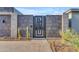 Modern block privacy gate with geometric metalwork, desert landscaping, and blue skies at 7130 E Navarro Way, Scottsdale, AZ 85266