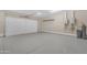 Clean and spacious garage featuring a white garage door, ample storage space, and organized utility systems at 7130 E Navarro Way, Scottsdale, AZ 85266