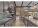 Modern kitchen with stainless steel appliances, gray cabinets, and open floor plan at 7130 E Navarro Way, Scottsdale, AZ 85266