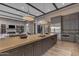 Open-concept kitchen with large island, modern lighting, and views into the living space at 7130 E Navarro Way, Scottsdale, AZ 85266