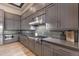 Modern kitchen with stainless steel appliances, gray cabinets, and backsplash at 7130 E Navarro Way, Scottsdale, AZ 85266