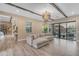 Bright living room features wood flooring, ceiling beams, recessed lighting, and large sliding glass doors at 7130 E Navarro Way, Scottsdale, AZ 85266