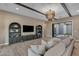 Living room features ceiling beams, built-in shelving, recessed lighting, and opens to the outdoor space at 7130 E Navarro Way, Scottsdale, AZ 85266