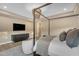 Beautiful main bedroom featuring a media center, designer lighting and a luxurious canopy bed at 7130 E Navarro Way, Scottsdale, AZ 85266