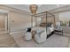 Stylish main bedroom with a four-poster bed, designer lighting, neutral tones and ample natural light at 7130 E Navarro Way, Scottsdale, AZ 85266