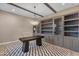 Office with custom built-in shelving, a modern desk, chair, decorative rug, and a stylish chandelier at 7130 E Navarro Way, Scottsdale, AZ 85266