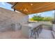 Stylish outdoor kitchen featuring a built-in grill, bar seating, and decorative stone accents perfect for entertaining at 7130 E Navarro Way, Scottsdale, AZ 85266