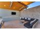Cozy outdoor living space with comfortable seating, a stone accent wall, and a mounted TV at 7130 E Navarro Way, Scottsdale, AZ 85266