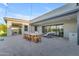 Inviting outdoor patio featuring an alfresco dining area, comfortable seating, and seamless access to indoor living spaces at 7130 E Navarro Way, Scottsdale, AZ 85266