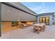 Relaxing outdoor patio with stylish seating, dining area, and retractable sun shades for comfortable entertaining at 7130 E Navarro Way, Scottsdale, AZ 85266