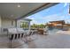 Outdoor patio area featuring lounge seating, dining table, and views of the pool and covered outdoor bar at 7130 E Navarro Way, Scottsdale, AZ 85266