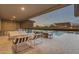Covered outdoor patio area with comfortable lounge seating and a dining area, perfect for entertaining at 7130 E Navarro Way, Scottsdale, AZ 85266
