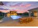 Inviting pool area with a covered patio, an outdoor dining space, and a bar ready for entertaining at 7130 E Navarro Way, Scottsdale, AZ 85266
