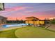 Backyard pool with a putting green and a covered outdoor kitchen and bar area at 7130 E Navarro Way, Scottsdale, AZ 85266