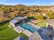 Luxurious pool area featuring a modern cabana, lounge seating, putting green, and well-manicured landscaping at 7130 E Navarro Way, Scottsdale, AZ 85266