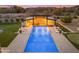Overhead view of resort-style pool with a pergola, lounge chairs, putting green, and desert landscaping at 7130 E Navarro Way, Scottsdale, AZ 85266