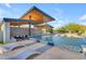Relaxing pool area under a modern pergola featuring waterfall features and stylish lounge chairs at 7130 E Navarro Way, Scottsdale, AZ 85266