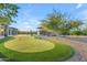 Backyard putting green for golf enthusiasts, complemented by an outdoor kitchen and beautiful landscaping at 7130 E Navarro Way, Scottsdale, AZ 85266
